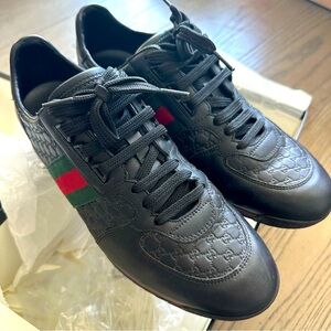 Authentic Gucci black leather grosgrain trim sneakers.